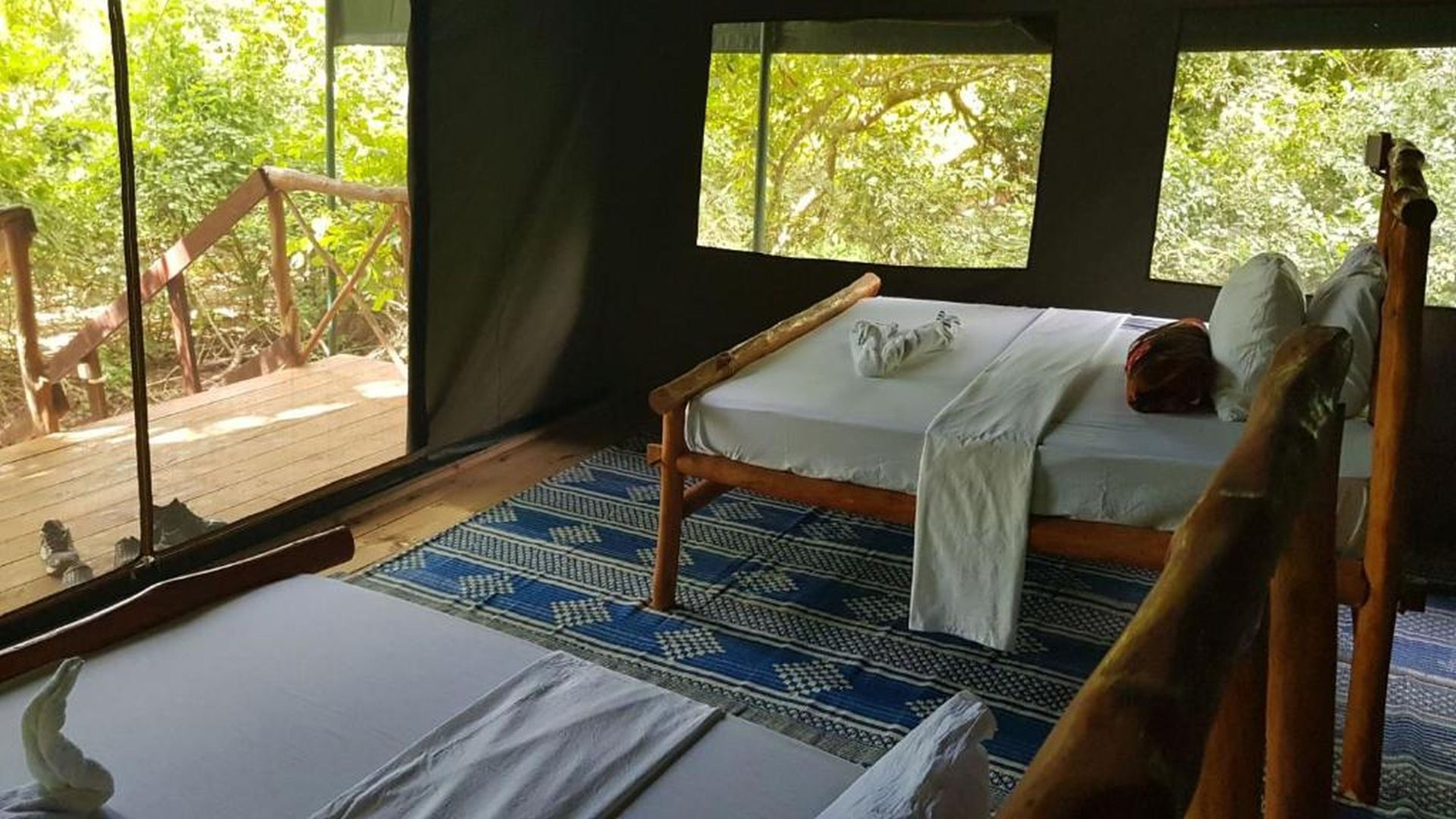 Canvas accommodation interior with timber-framed beds
