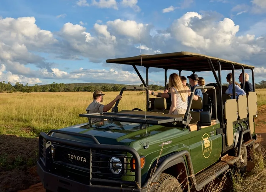 Safari vehicle parked in an open landscape in the Selous region